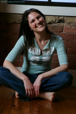 Slanke vrouw van begin twintig trekt haar beha uit