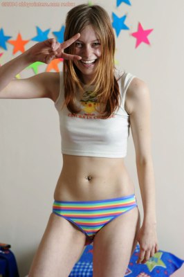 Dun meisje met sexy piercings uit de kleren en helemaal bloot