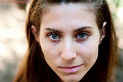 Een verbluffend mooi meisje loopt naakt door het bos